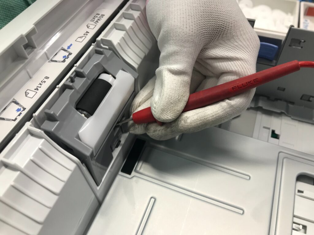 Technician servicing a business printer