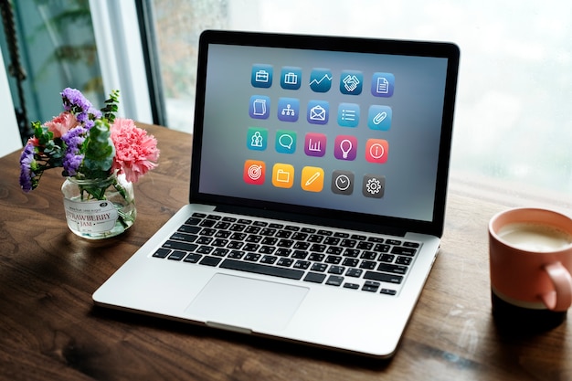 Free photo laptop on a wooden table