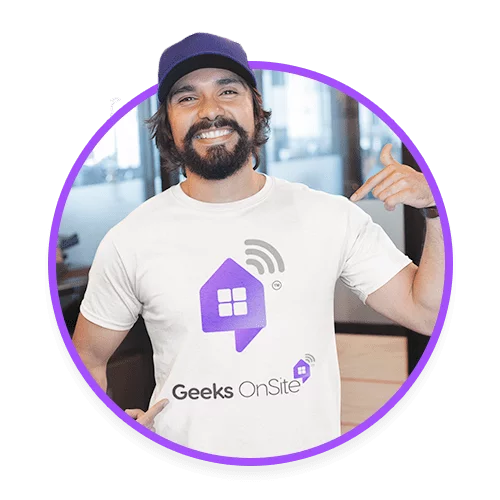 Male Geeks on Site employee with a beard in a hat and white branded shirt.